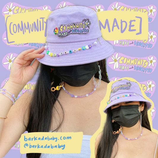 purple background with community made and dedicated stickers repeated in the back. yellow text boxes that read “[community made]. barkadababy.com @barkadababy “ in purple and blue text. there are two pictures of a masked person wearing a purple bucket hat with a a necklace and hoop earrings collages together.