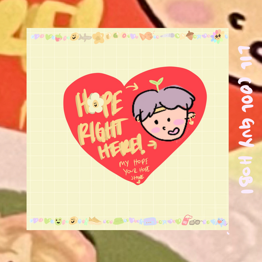 yellow grided print woth a red heart in the center reading "hope right here! my hope your hope jhope" adorned with various symbols on the border