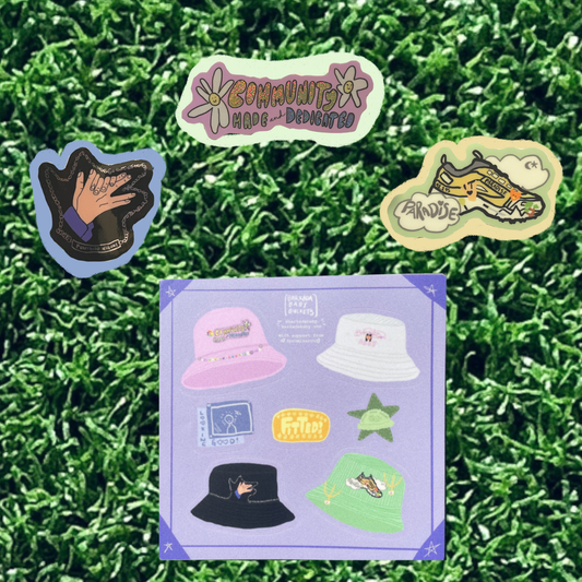 fake grass background with picture of three individual stickers (megumi with blue background community made with a green background, and track 5 with a yellow) and a sticker sheet on the bottom